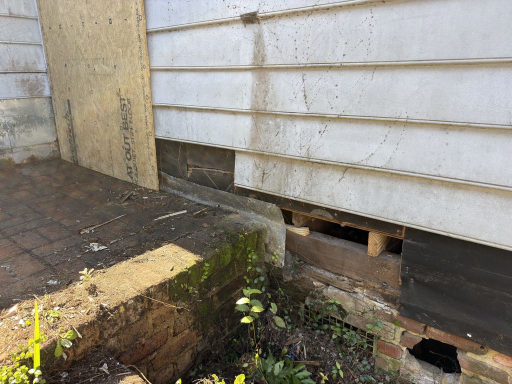 Brick piers and crawl space along the side of 300 N. Academy Street in Kingstree