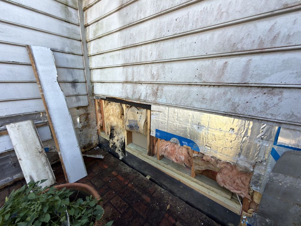 Siding opened at the base of the wall at 300 N. Academy Street during renovation