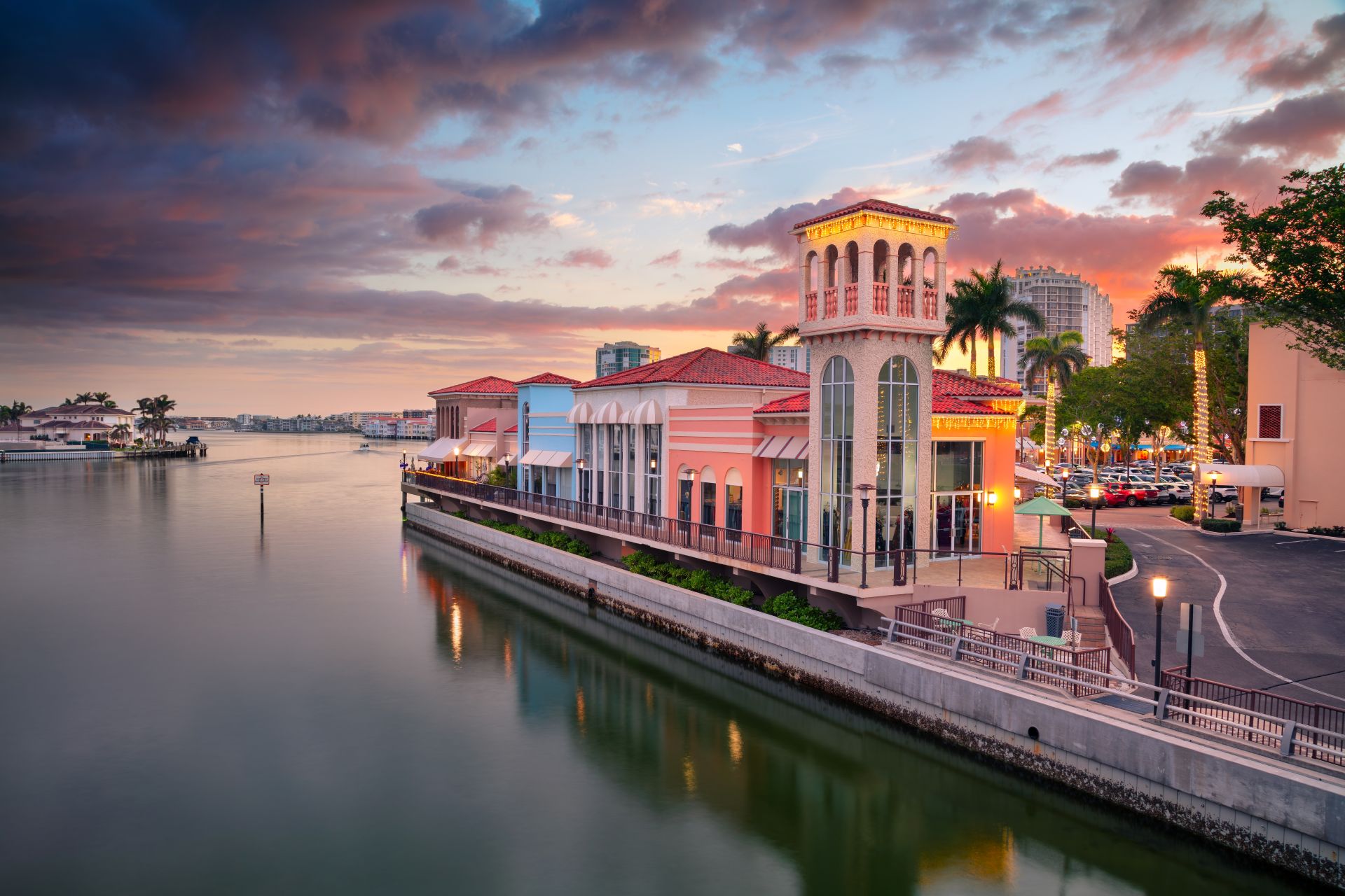 Naples, Florida, USA. Cityscape image of Naples, Florida with reflection of the city skyline in the water at beautiful sunset.