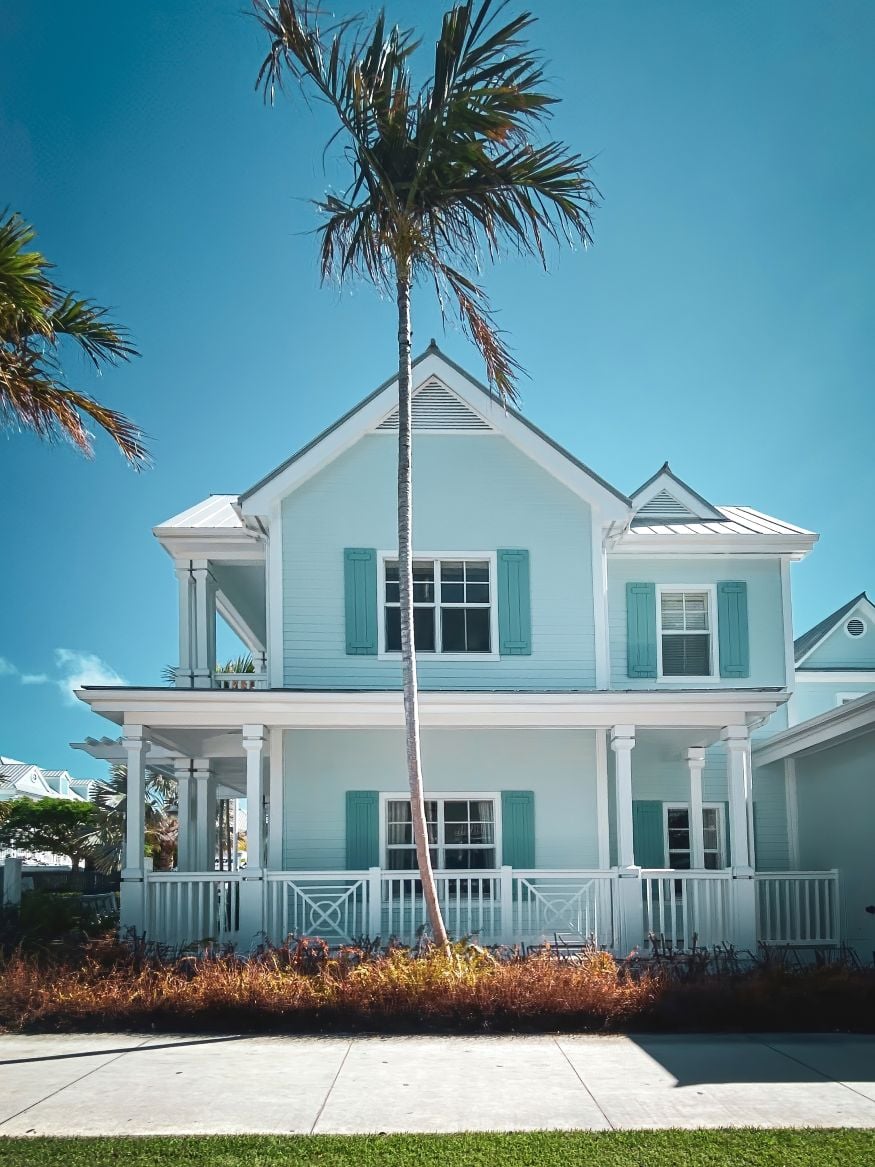 Picturesque house with palm trees in the streets of Key West, Florida, USA against blue sky