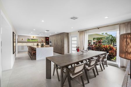 Dining room table looking towards kitchen and island at 3481 NE 18th Avenue Oakland Park FL
