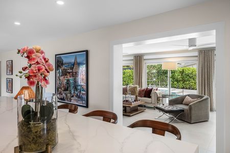 View into living room from the open kitchen with orchids on quartz island at 3481 NE 18th Avenue Oakland Park FL