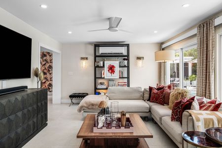 Bookcase and sectional sofa on 35 inch Italian tile floors in living room at 3481 NE 18th Avenue Oakland Park FL