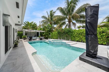 Heated saltwater swimming pool with waterfall at 3481 NE 18th Avenue Oakland Park FL