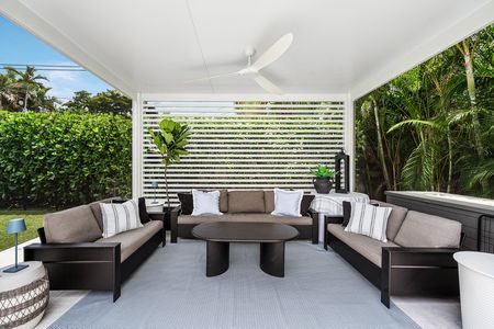 Ceiling fan and outdoor furniture on outdoor rug inside the screened cabana at 3481 NE 18th Avenue Oakland Park FL