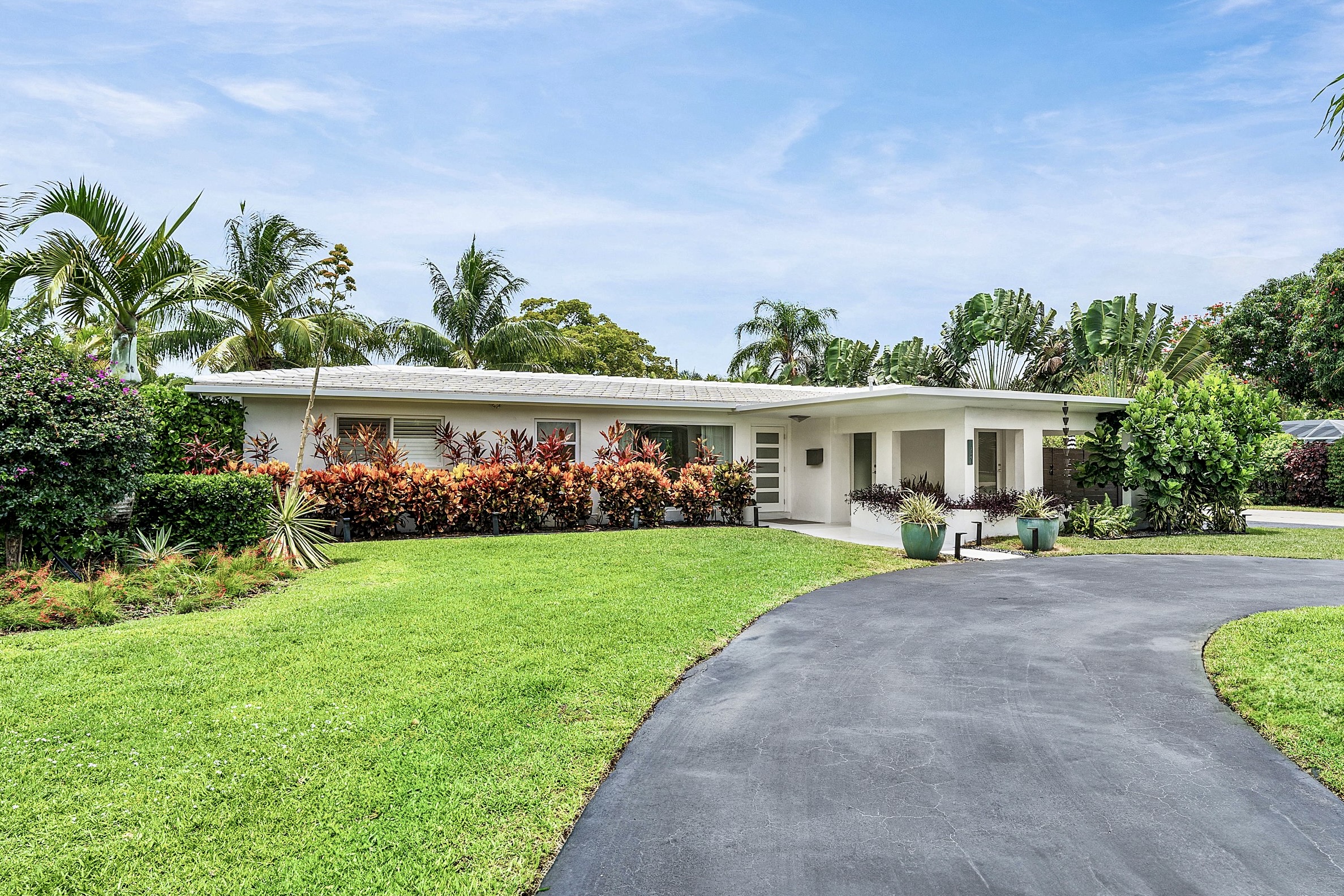 Exterior view of 3481 NE 18th Avenue, a remodeled Oakland Park home on a landscaped corner lot.