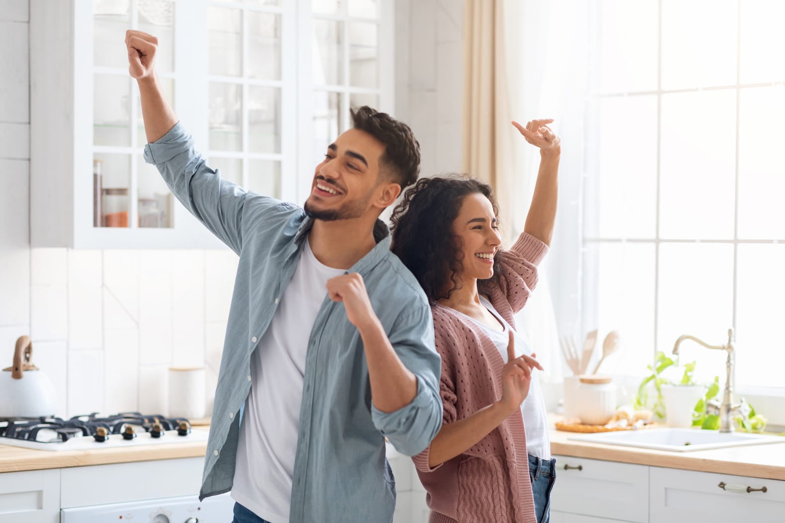 Domestic Fun. Cheerful Middle Eastern Spouses Dancing In Kitchen, Loving Arab Couple Fooling And Laughing At Home, Young Family Of Two Enjoying Spending Weekend Time Together, Copy Space (1) (1)