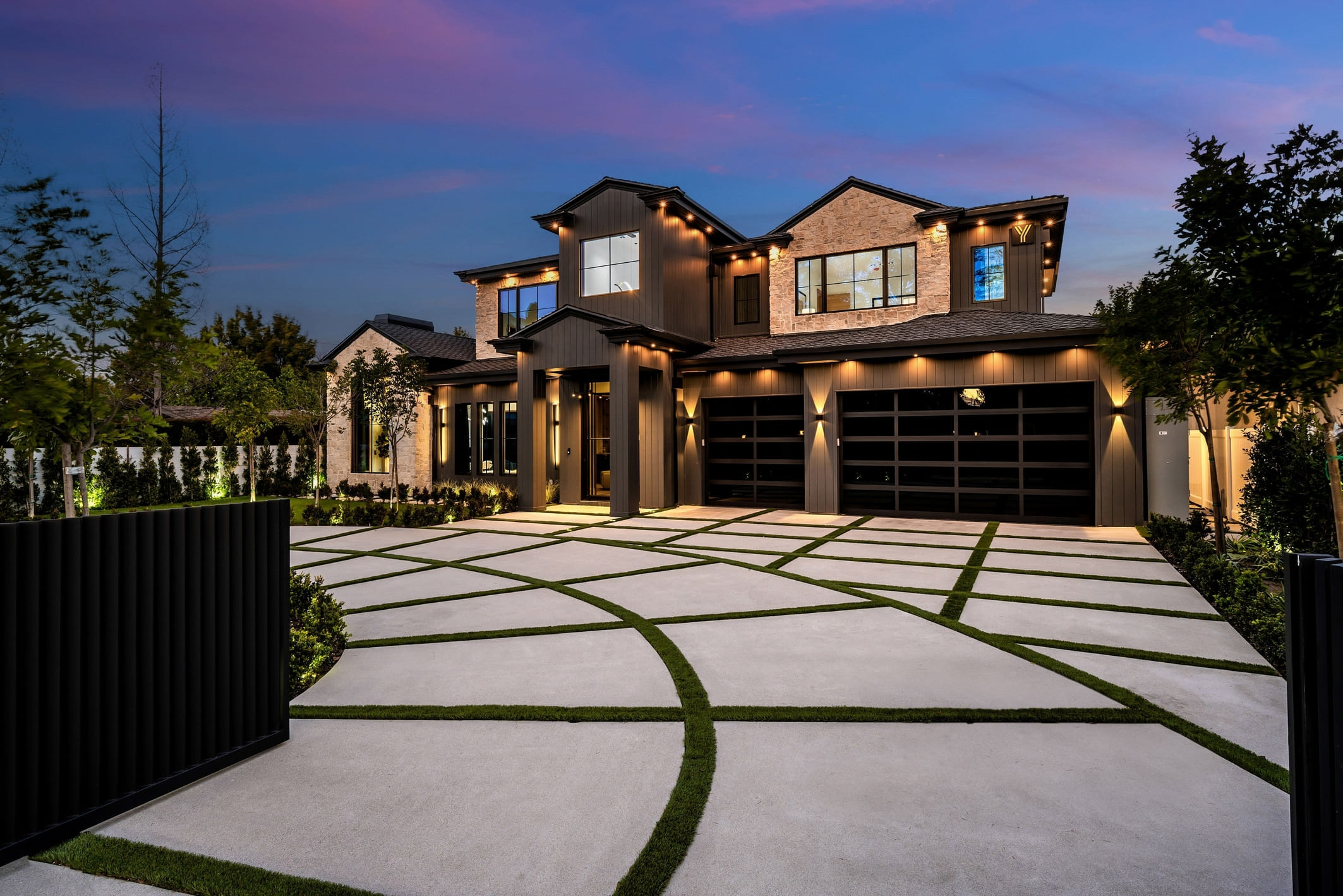 Modern luxury house with a beautifully landscaped driveway at dusk. (1) (1)