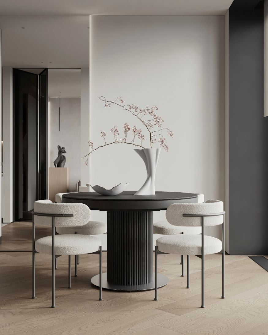 Modern minimalist dining area with round table and neutral tones, contemporary interior design concept.