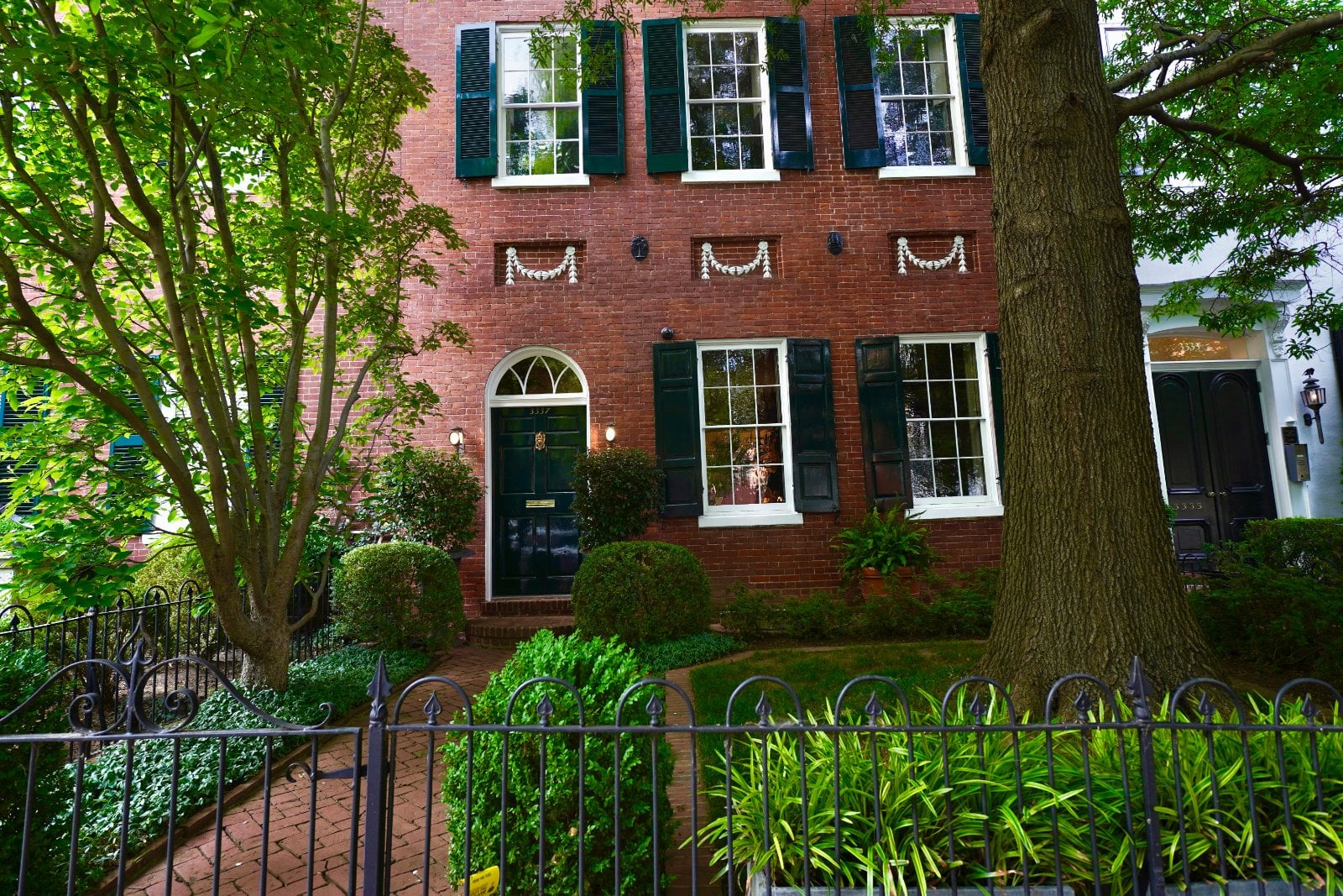 Federal-style brick house with black shutters