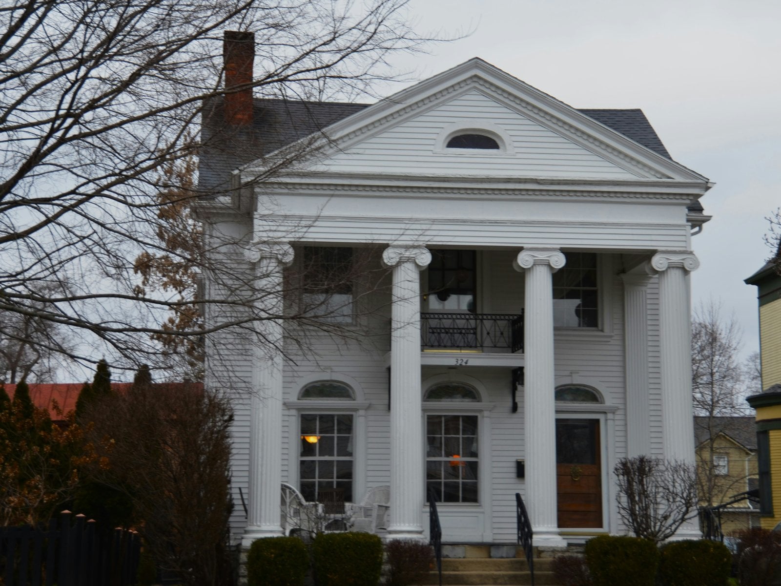 Greek Revival home with full-height white columns
