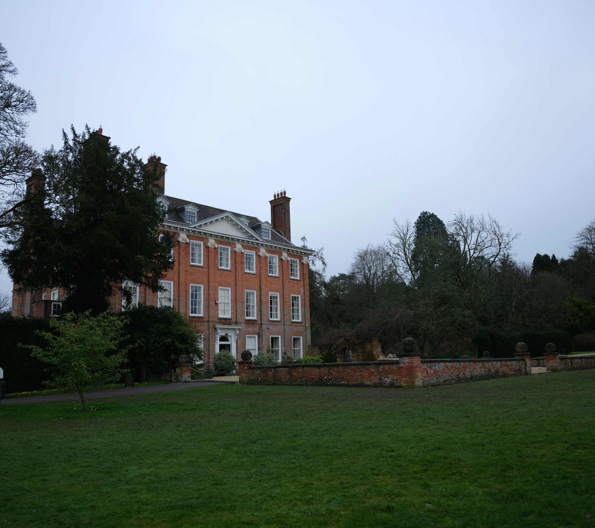 Distinguished brick estate home with landscaped lawn