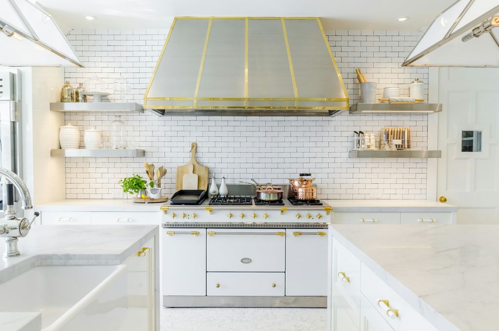 Classic white kitchen with statement range and brass-trimmed hood