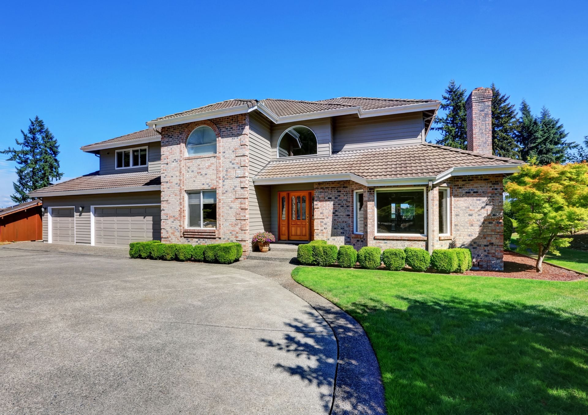 Luxury Brick house with beautiful curb appeal with perfectly trimmed front lawn. Northwest, USA
