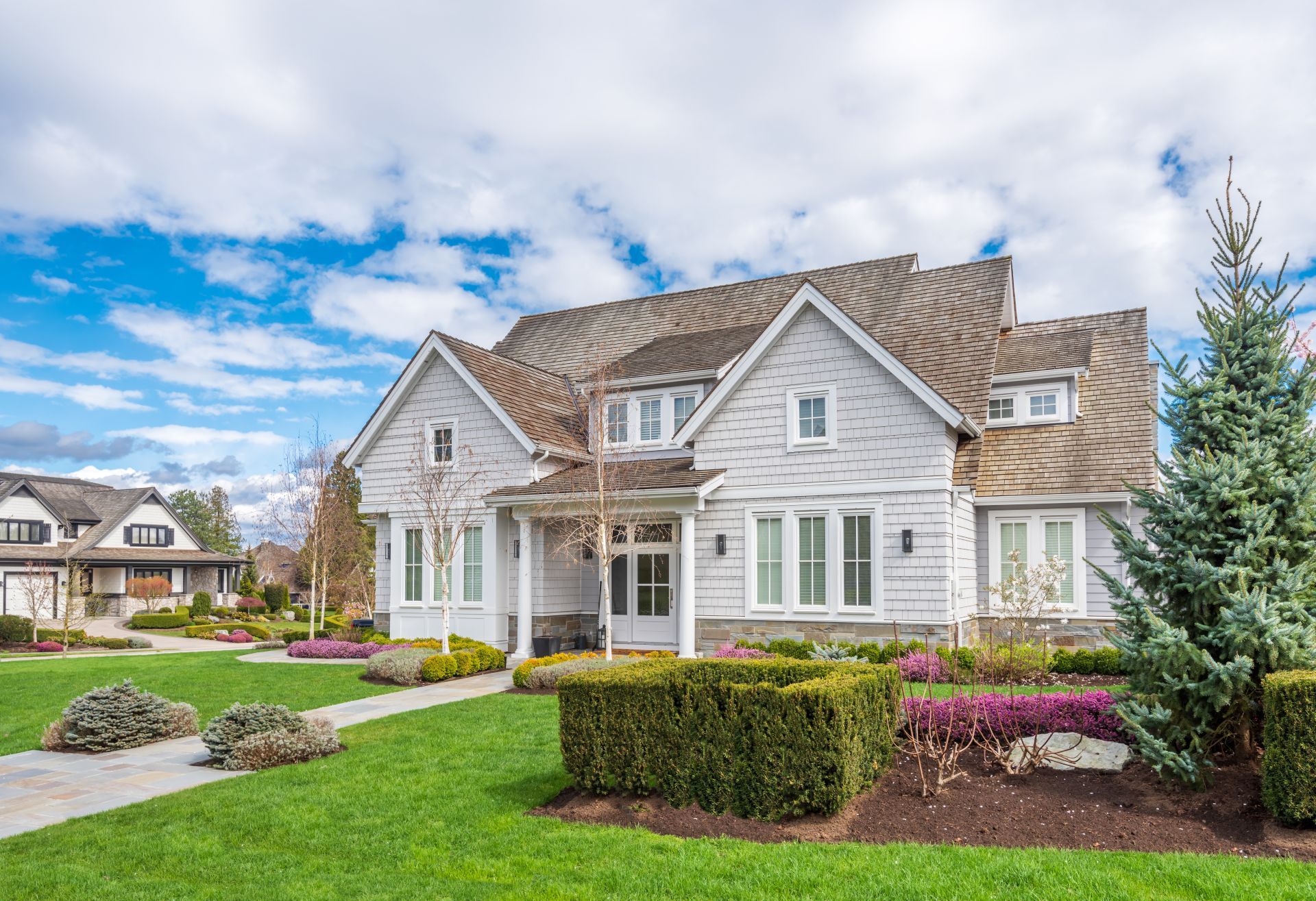 Beautiful exterior of newly built luxury home. Yard with green grass and walkway lead to front entrance. (1)