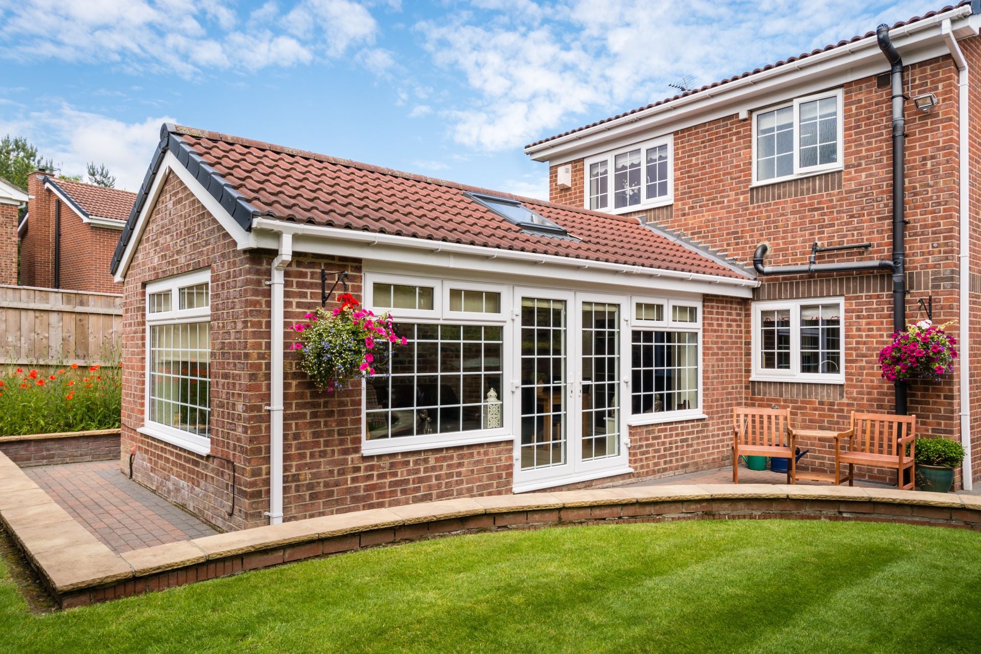 Modern Sunroom external Modern Sunroom or conservatory extending into the garden, surrounded by a block paved patio