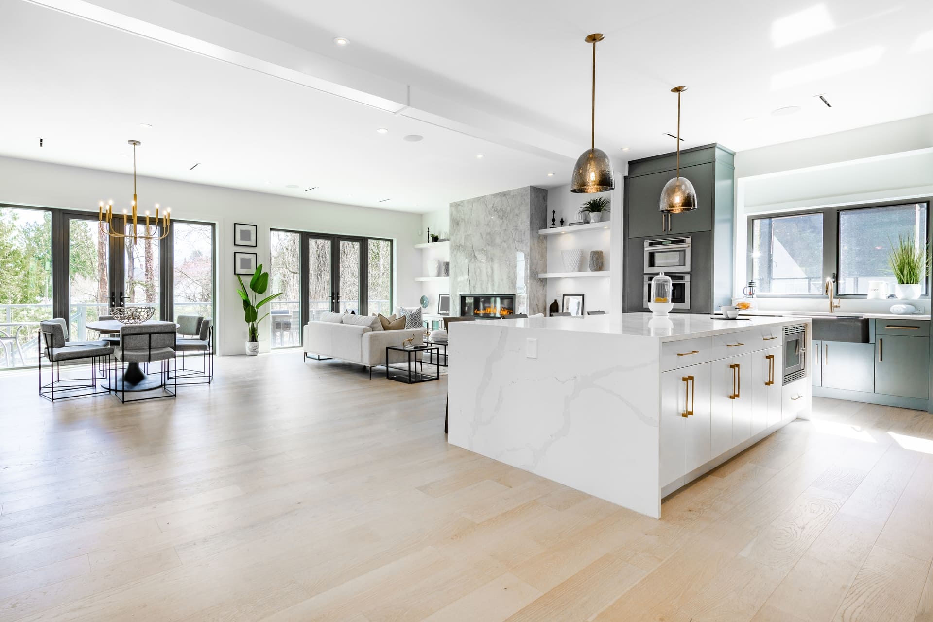 contemporary kitchen spice kitchen with grey cabinets white marble counter top sinks range appliances eating counter and pendant lights (1)