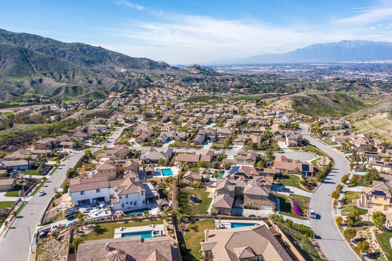 Aerial view of residential neighborhoods in Colton California with the San Bernardino Mountains in the background