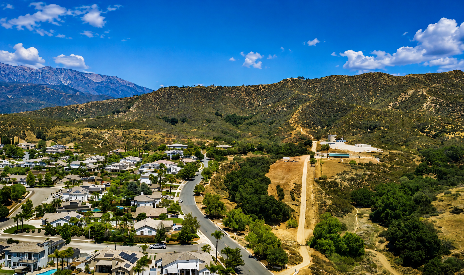 Aerial view of Whisper Ranch in Yucaipa California with homes, foothills and San Bernardino Mountains