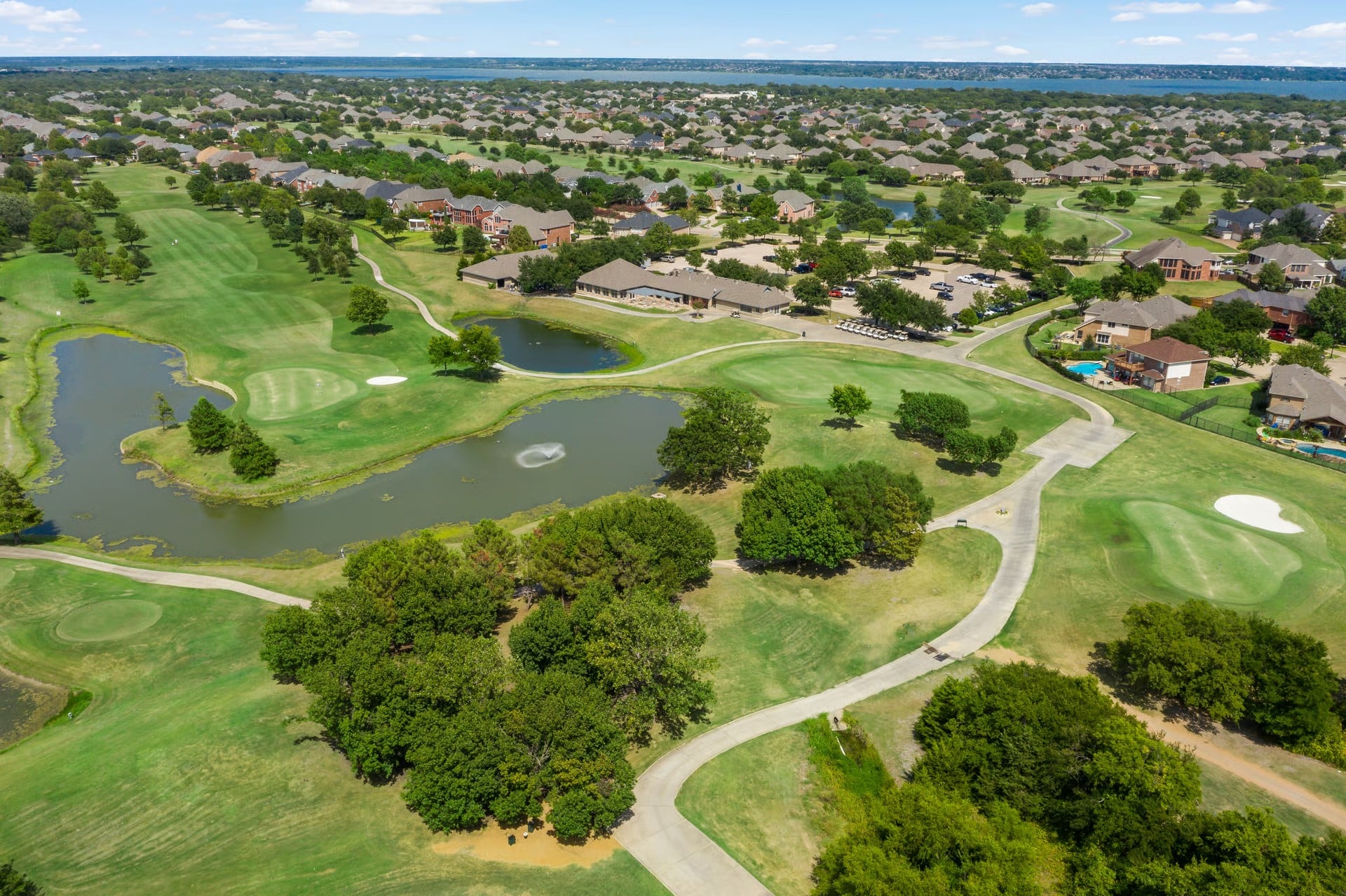 Aerial view of Waterview's golf course, community lakes, and homes in Rowlett, TX with Lake Ray Hubbard visible in the distance