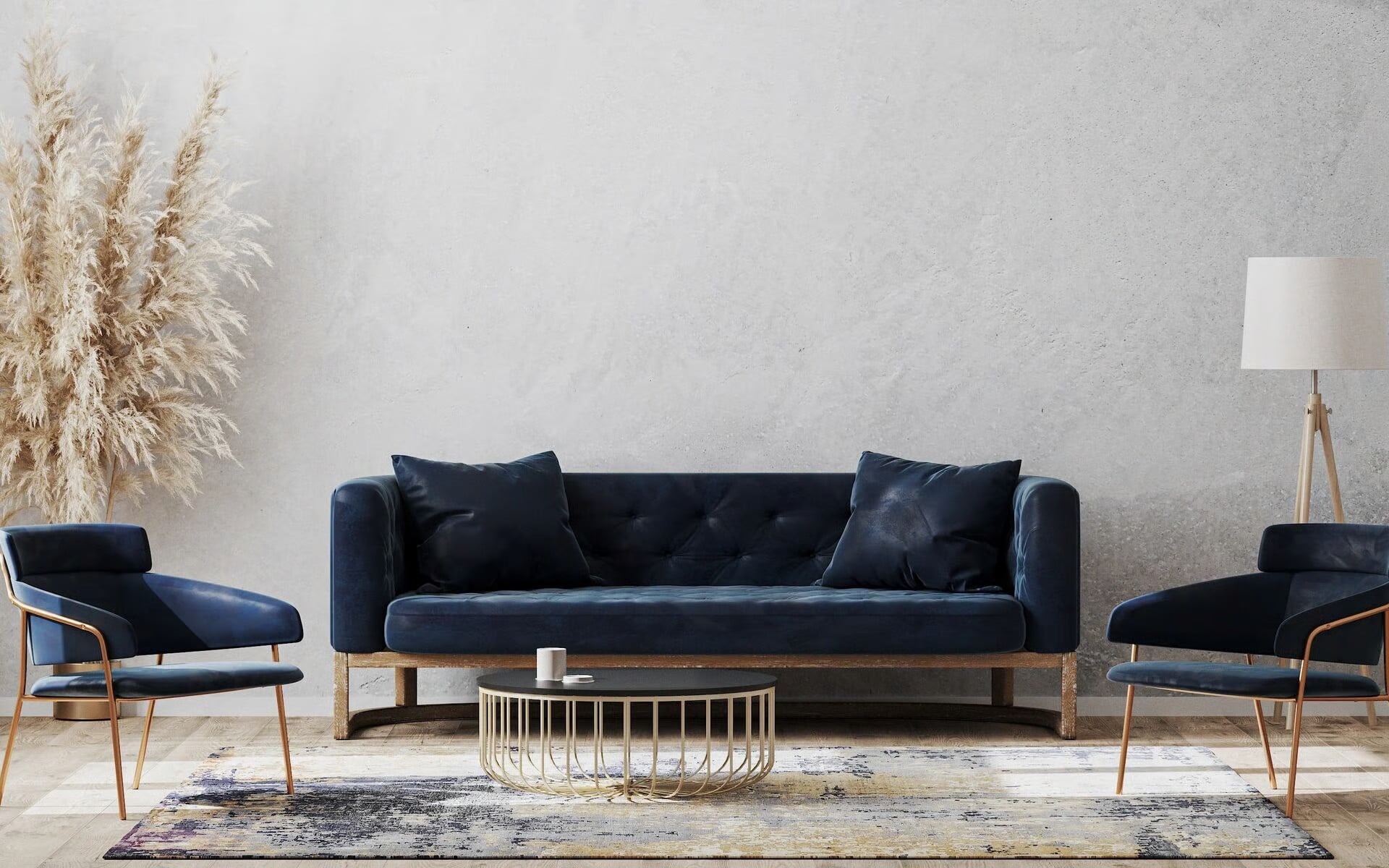 Navy velvet sofa and matching armchairs staged against a textured concrete accent wall