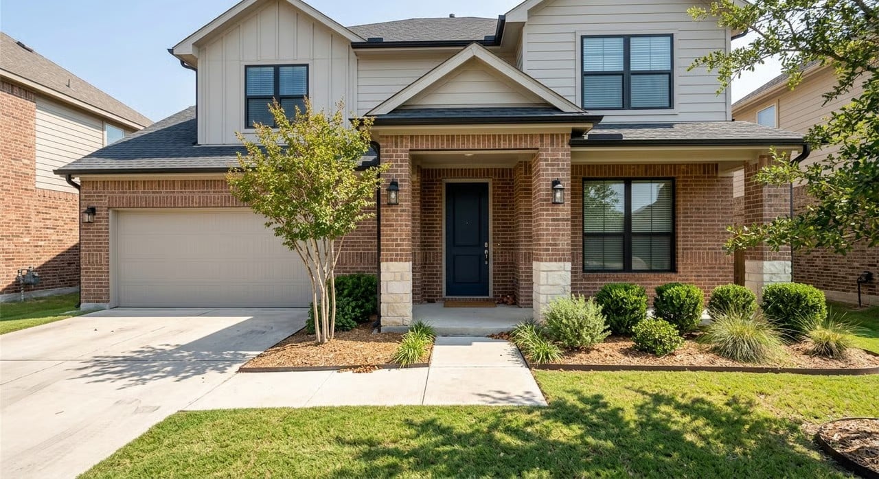 Two-story brick and board-and-batten home with covered entry in a North Texas neighborhood