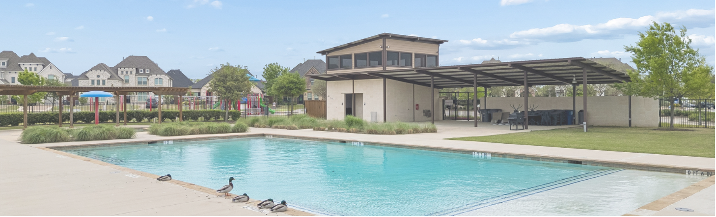 Community pool with shade pavilion and playground in Wylie, Texas