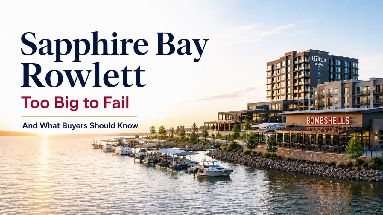 Sapphire Bay waterfront at dusk with the Hilton Tempo hotel, Bombshells restaurant, and marina in Rowlett, Texas