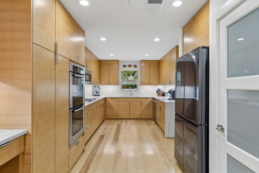 Kitchen with double ovens and full-height cabinetry | 9020 Glen Springs Dr, Dallas, TX 75243 | Lake Highlands