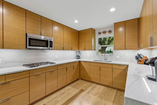 Kitchen with Quartzite counters and gas cooktop | 9020 Glen Springs Dr, Dallas, TX 75243 | Lake Highlands