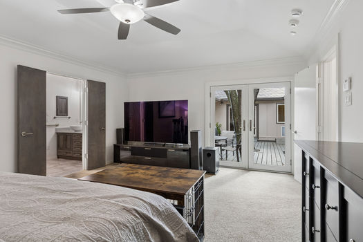 Primary bedroom with French doors to the courtyard | 9020 Glen Springs Dr, Dallas, TX 75243 | Lake Highlands