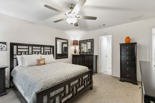 Bedroom with ceiling fan and dresser space | 9020 Glen Springs Dr, Dallas, TX 75243 | Lake Highlands