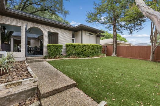 Backyard with turf and covered patio arches | 9020 Glen Springs Dr, Dallas, TX 75243 | Lake Highlands