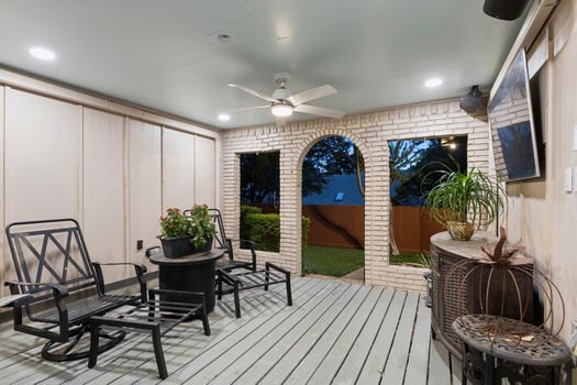 Covered patio with brick arches and ceiling fan | 9020 Glen Springs Dr, Dallas, TX 75243 | Lake Highlands