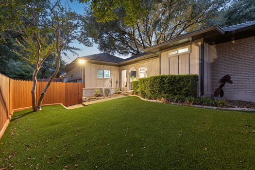 Backyard with turf at dusk | 9020 Glen Springs Dr, Dallas, TX 75243 | Lake Highlands