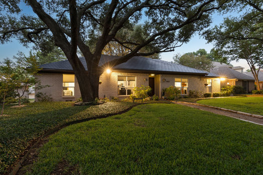 Front exterior with broad front lawn at dusk | 9020 Glen Springs Dr, Dallas, TX 75243 | Lake Highlands