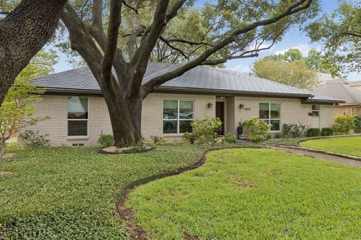 Front exterior with mature tree canopy | 9020 Glen Springs Dr, Dallas, TX 75243 | Lake Highlands