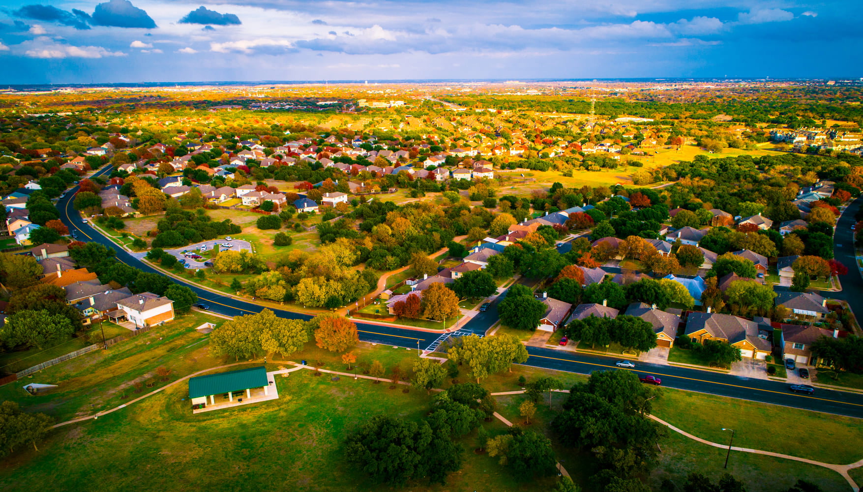 open Texas land for sale expanding housing development fall Autumn suburb suburbia round Rock Texas colorful landscape trees changing colors fall in central texas