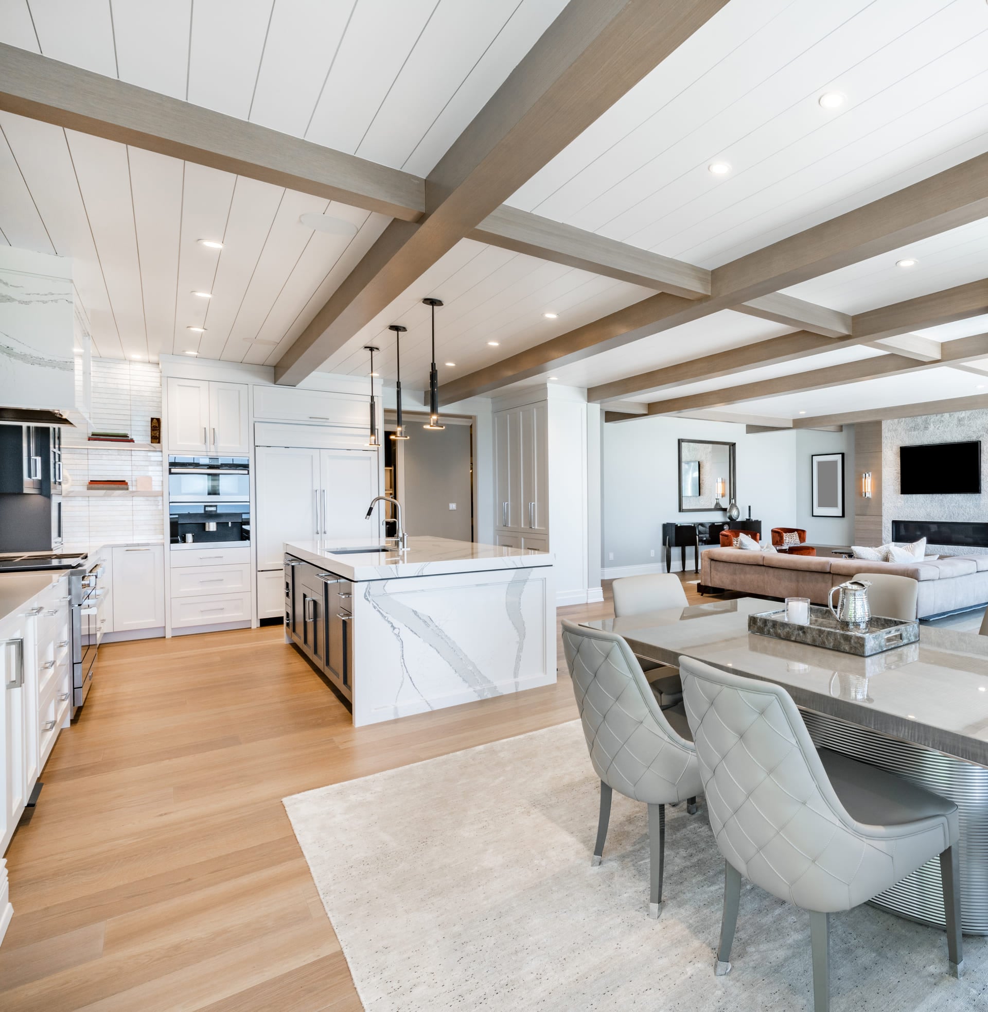Luxurious high end kitchen with stainless appliances marble and glass tile