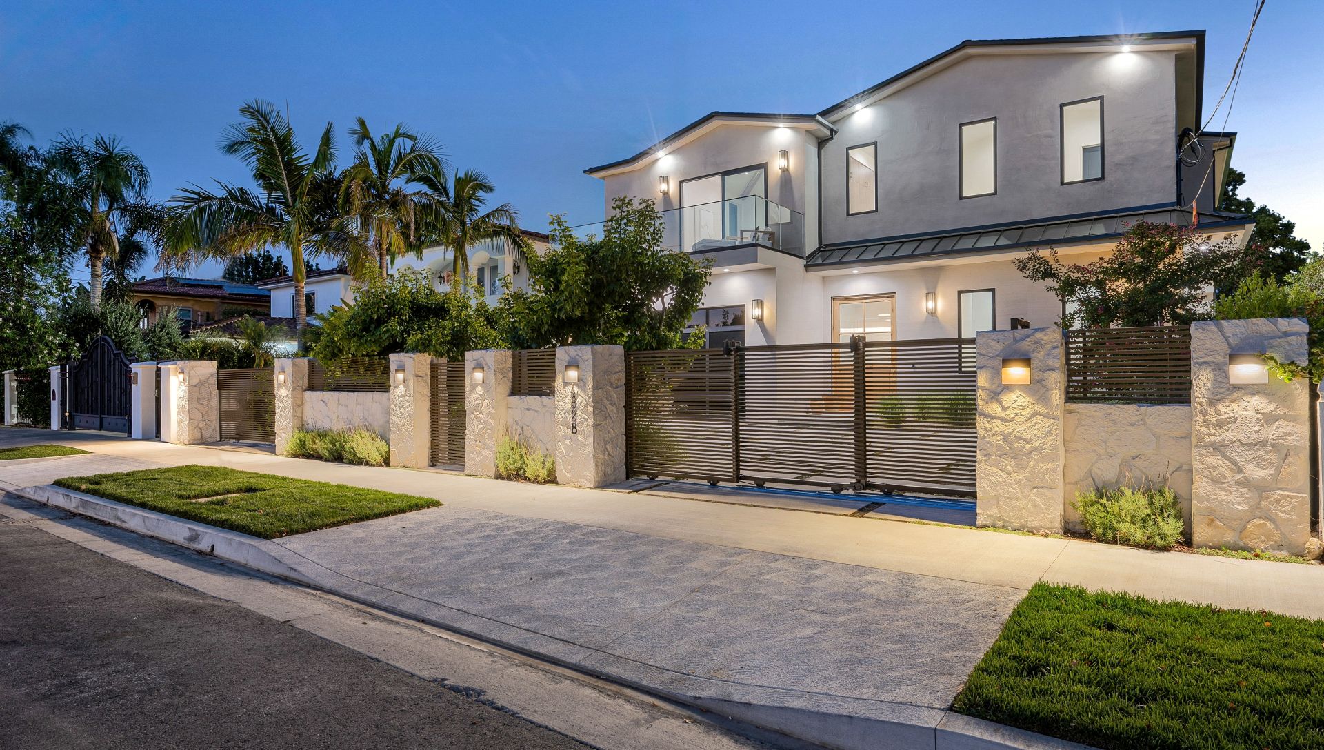 A house with a beautiful garden and metal gates. California, USA