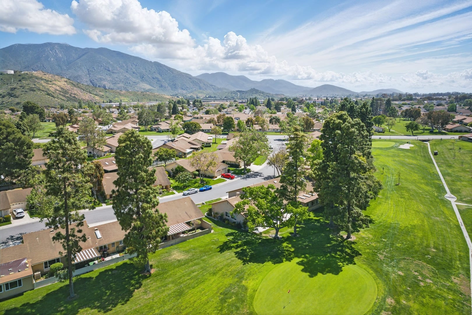 Comfortable California home with open-plan living, cozy bedrooms, golf course views, and lush backyard perfect for family living.