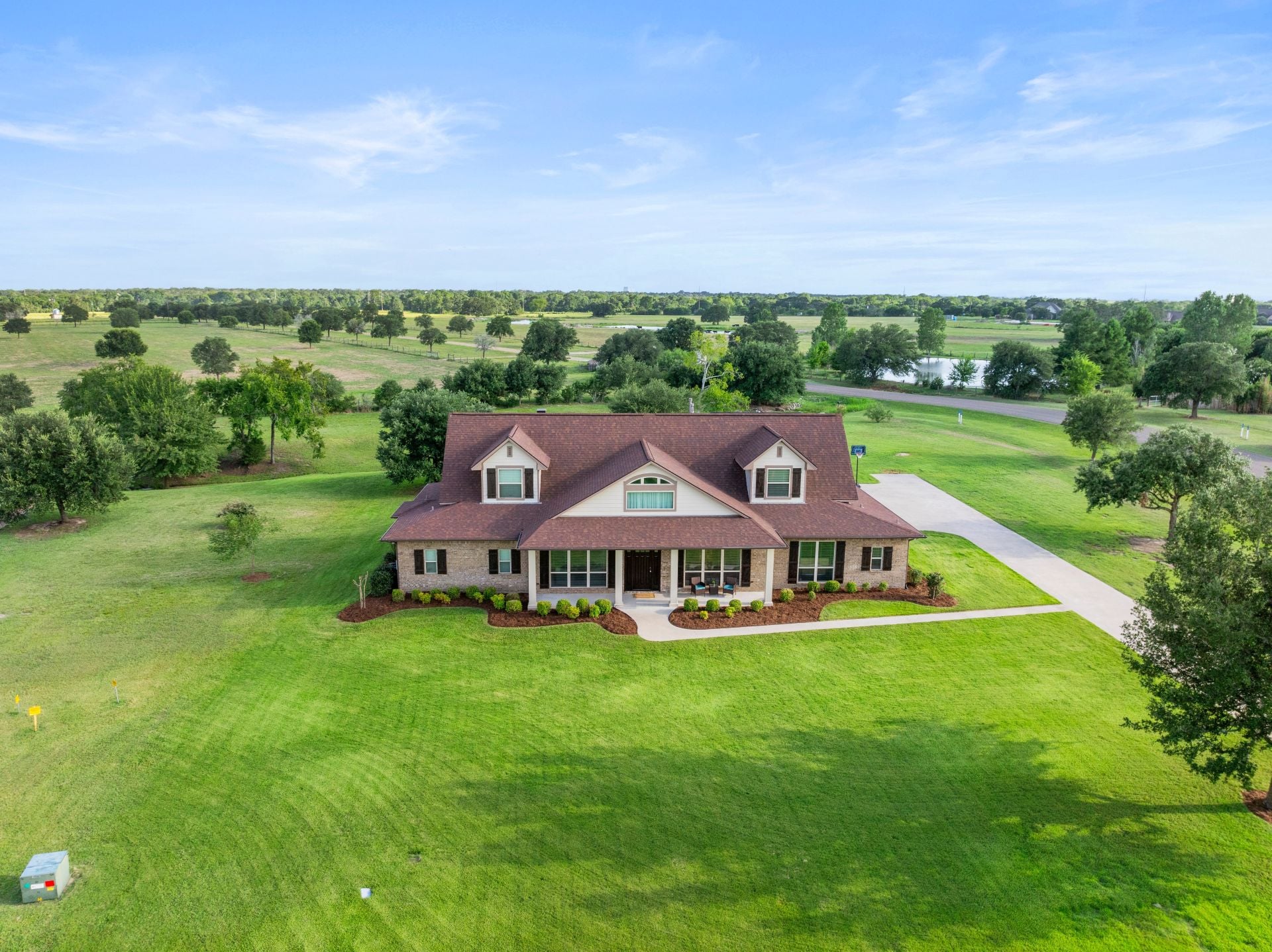 Real estate photos reveal a beautiful home situated on an acre of land. Featuring an expansive yard