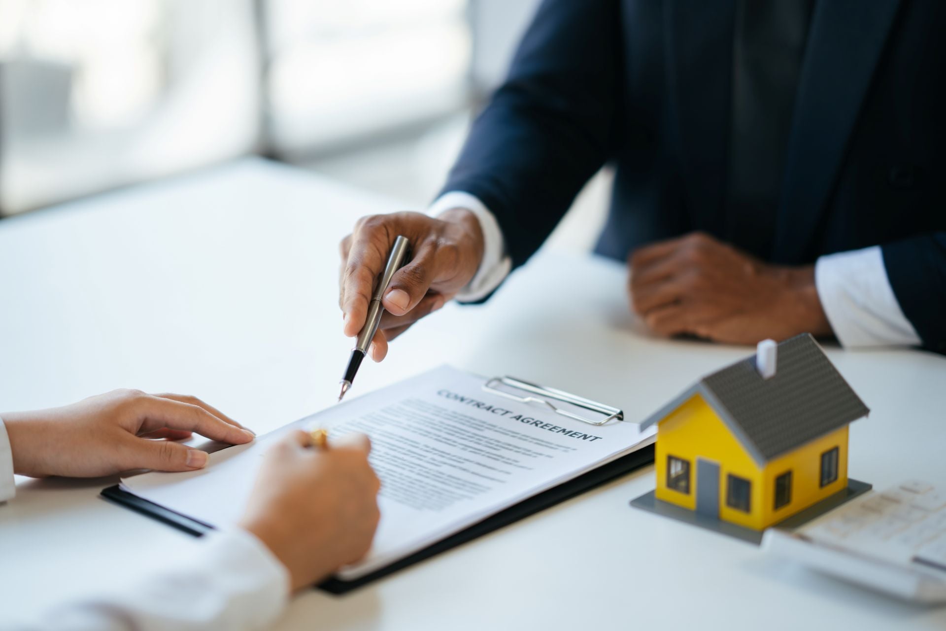 Professional real estate agent guiding and explaining the document process to the customer before the deal was done.