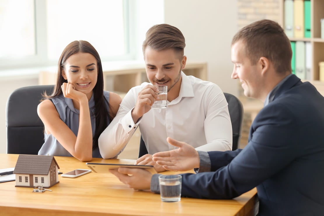 Real estate agent working with clients in office (1) (1)
