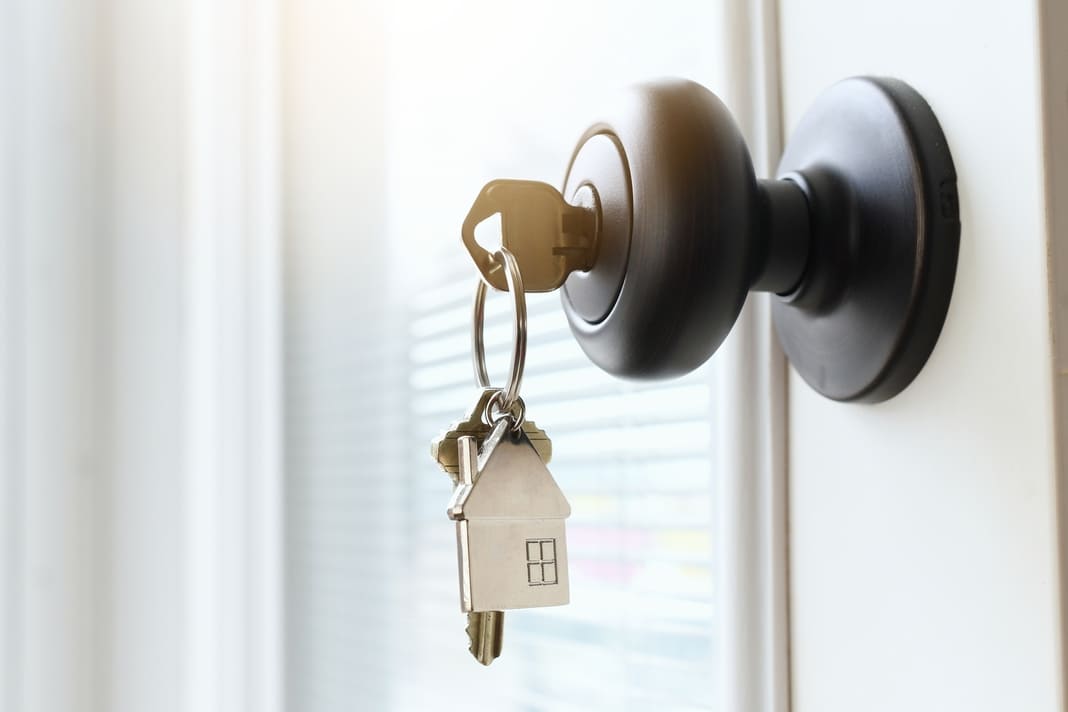 House keys hanging from a doorknob of a new home that is being sold by a realtor. (1) (1)