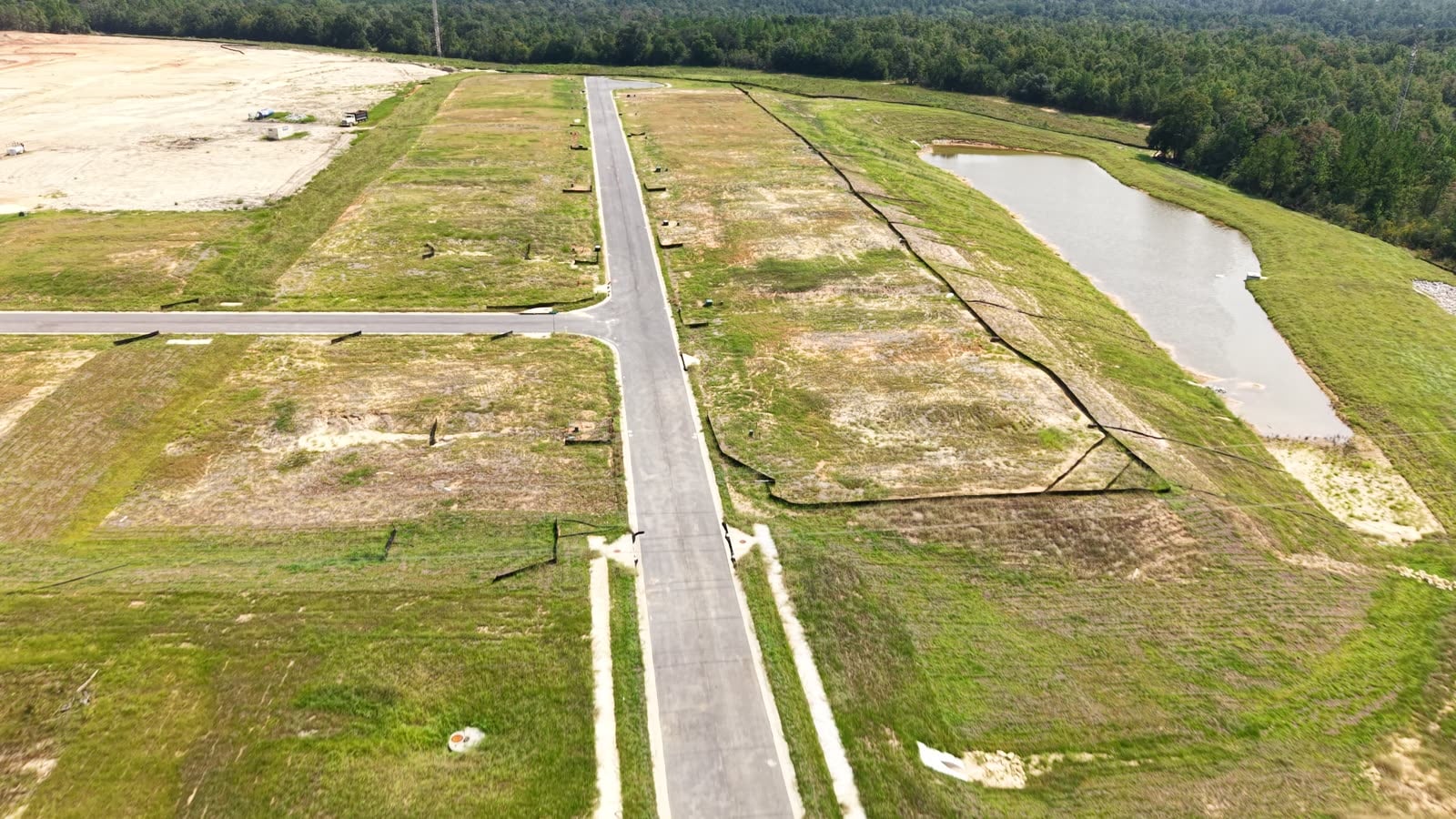 Open lots and a retention pond in a phase still under development.