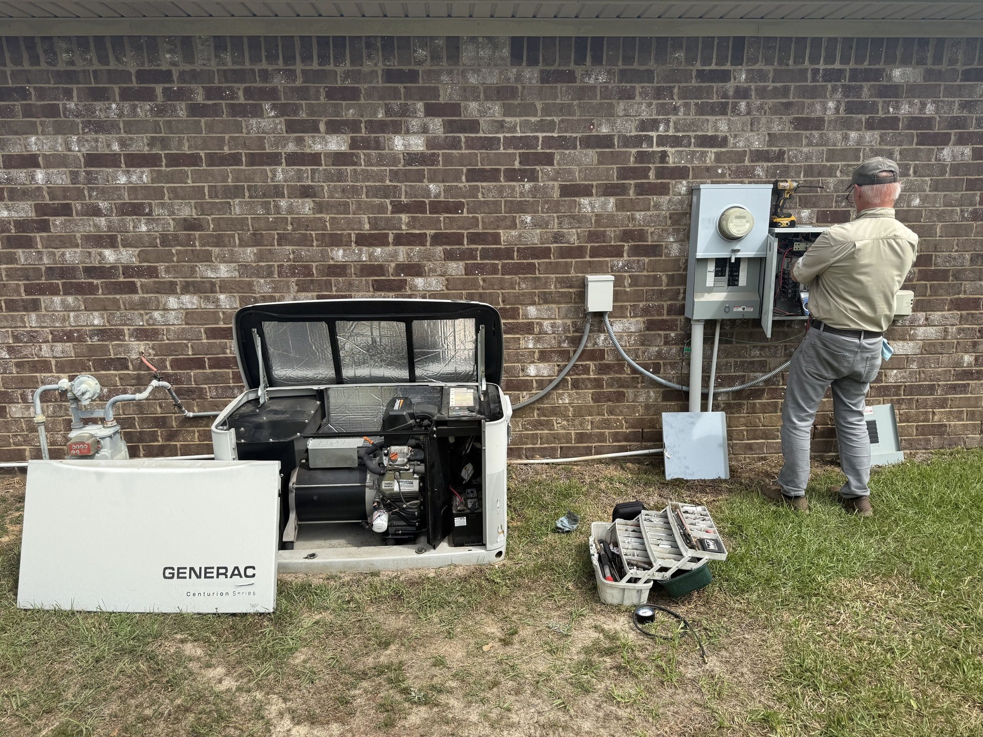 The generator, with the automatic transfer switch beside the meter.