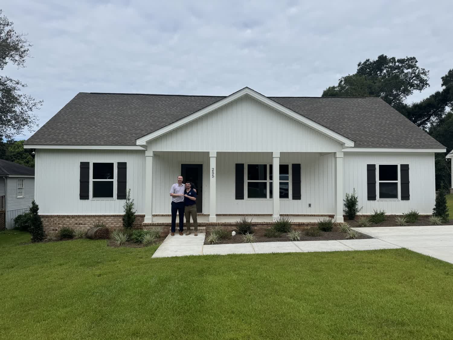Jacob and Zac outside their new construction home on Border Drive