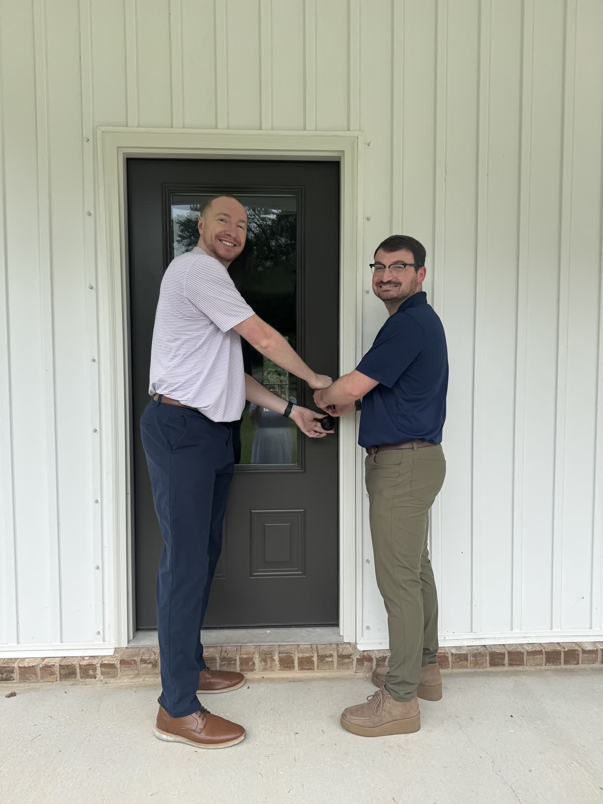 Jacob and Zac turning the key at their new home on Border Drive