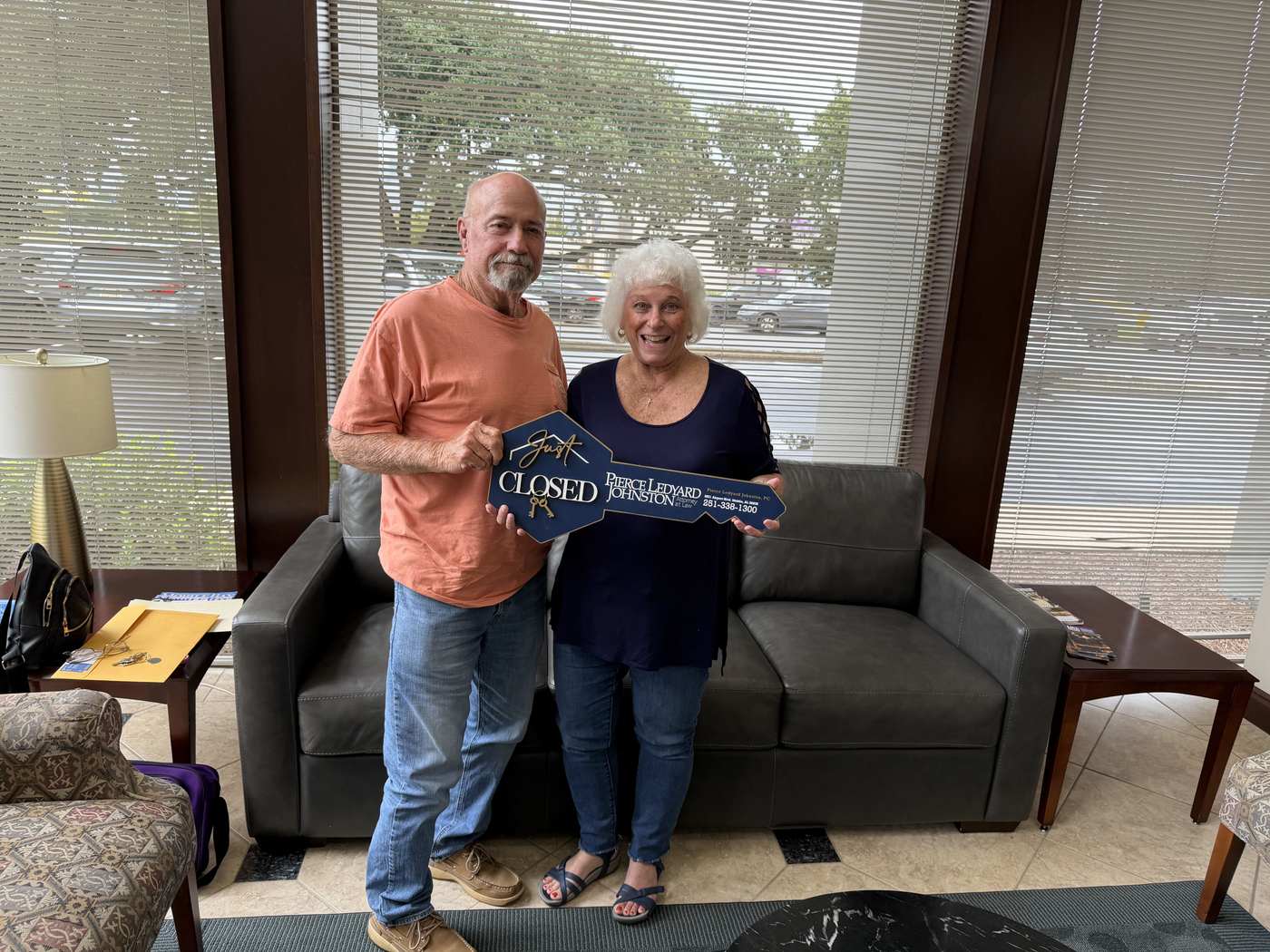 Tammy and Kenny celebrating with a closed sign